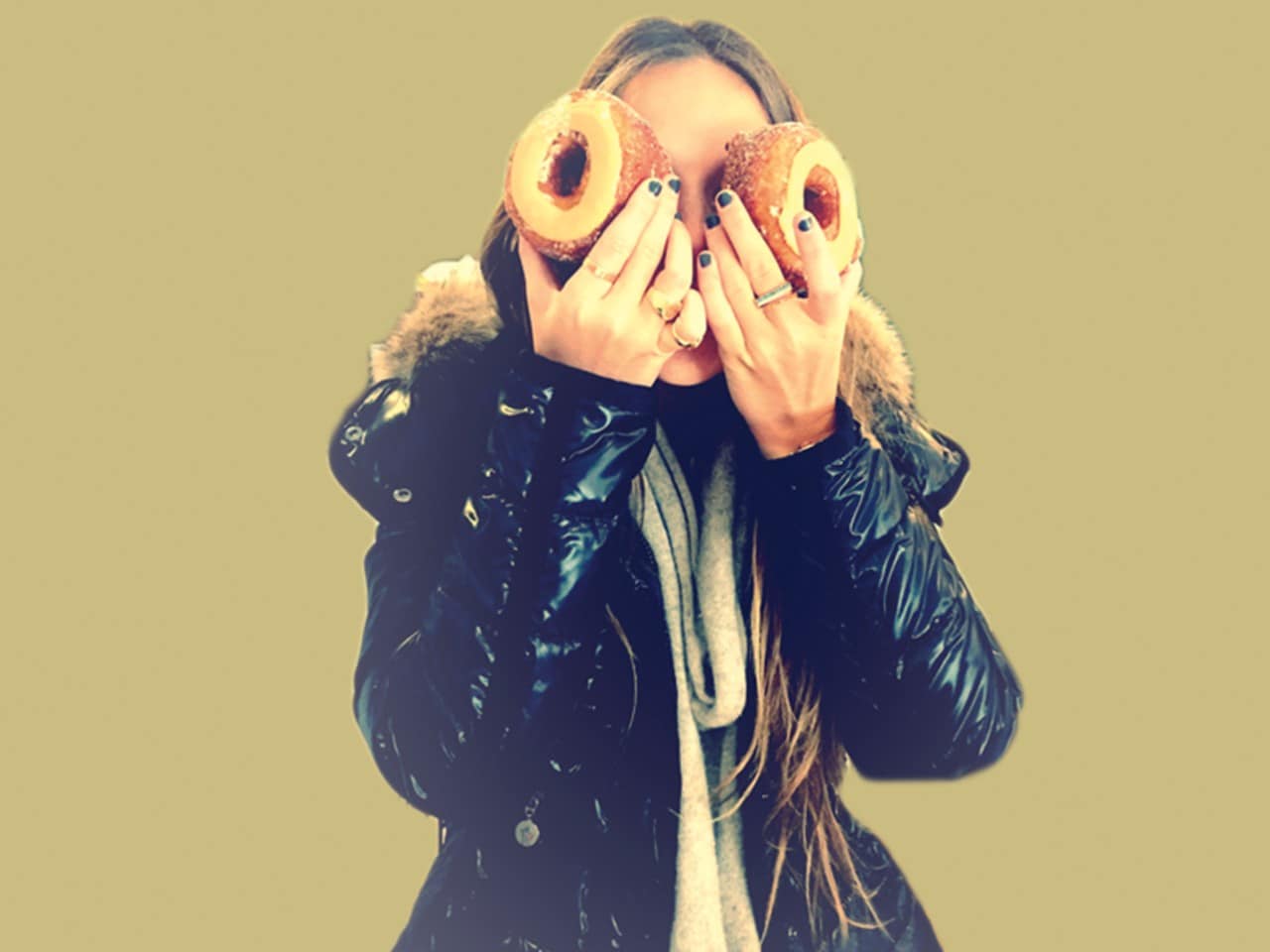 Photo of girl with donuts covering her eyes