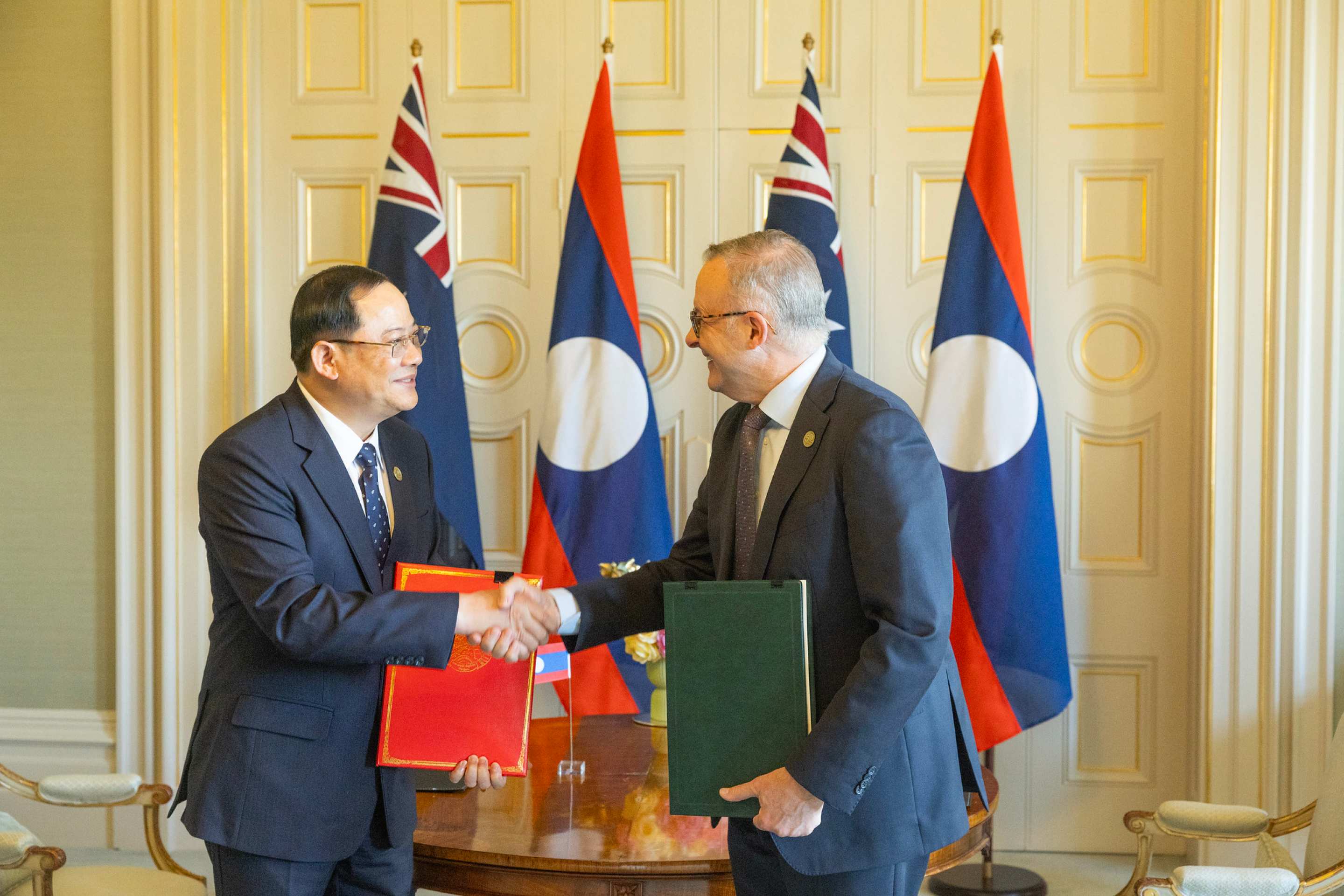 Prime Minister of Laos and Prime Minister of Australia shaking hands after signing an Australia-Laos Comprehensive Partnership at the ASEAN-Australia Special Summit 2024