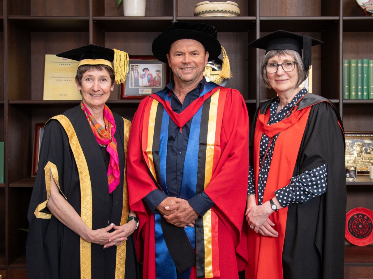 Image of three people in university gowns