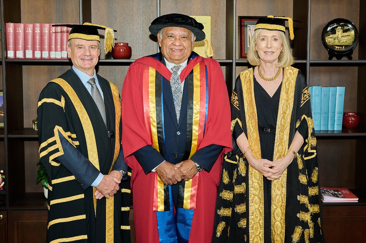 Professor Tom Calma stands between Deputy Chancellor Richard Freudenstein and Chancellor Belinda Hutchinson