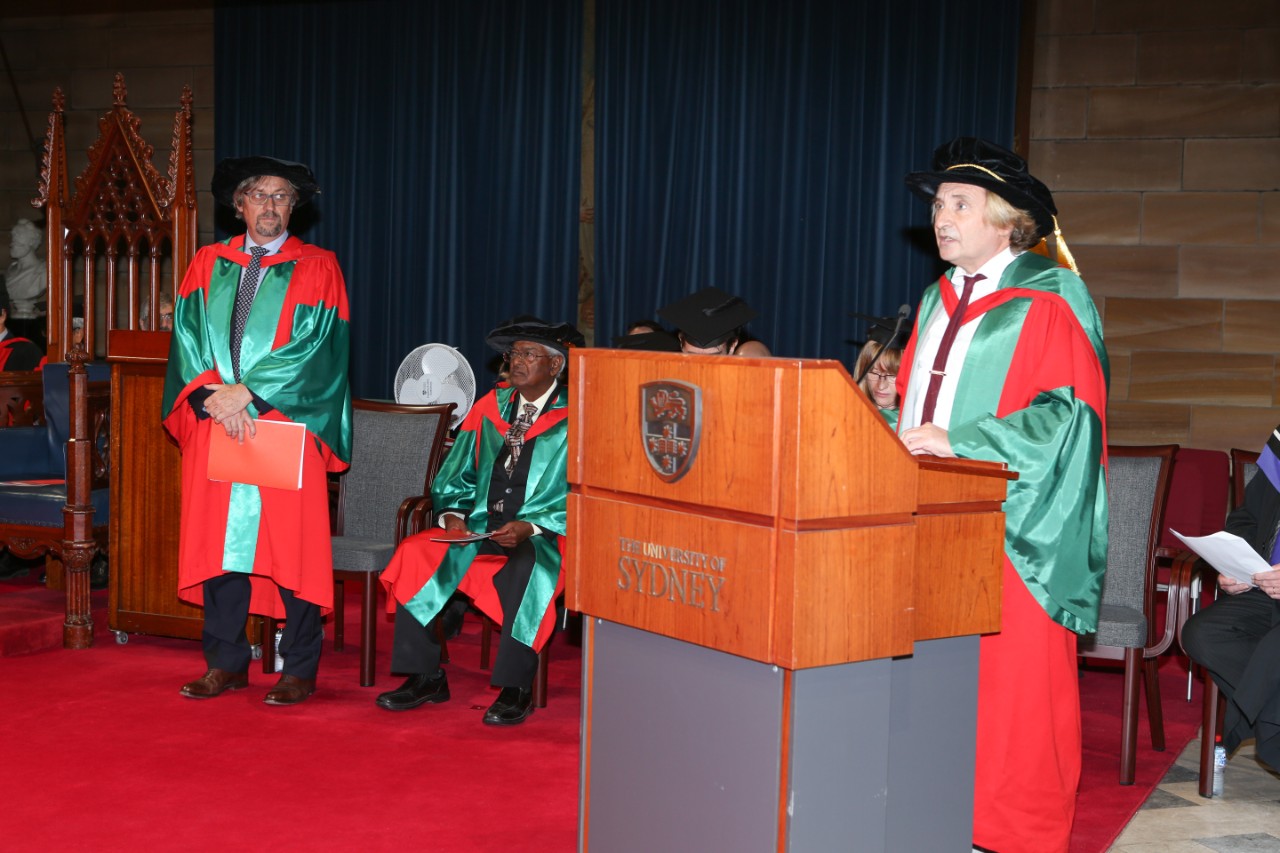 Professor Scott O'Neill standing, while Dr Sanjaya Rajaram looks on; addressed by University of Sydney Professor of Digital Agriculture and Soil Science Alex McBratney.