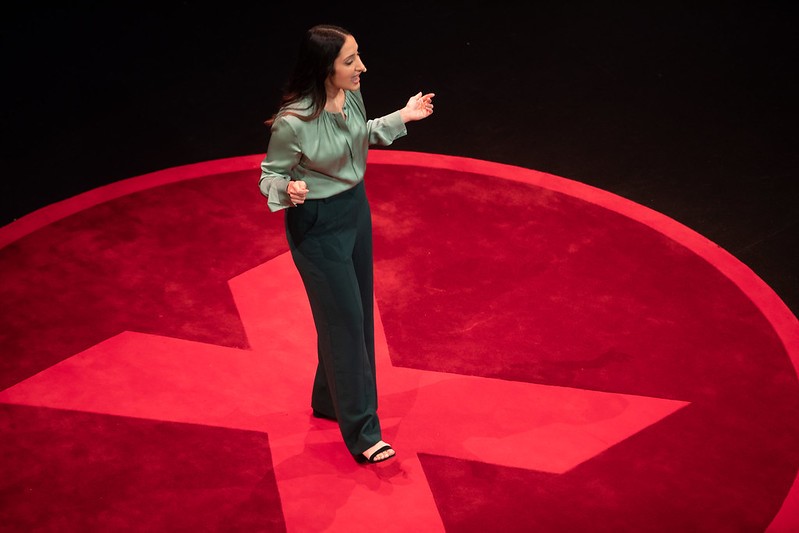 Young woman standing on the centre of an 'X' on stage
