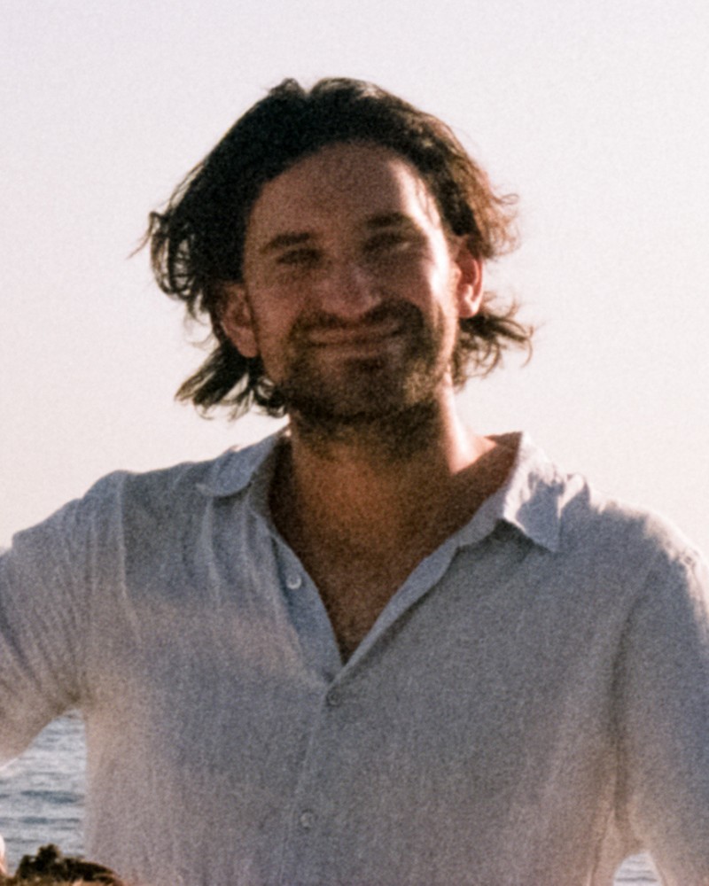 Headshot of a smiling young man outdoors