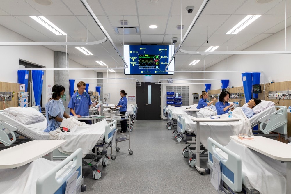 University of Sydney nursing students stand in simulation hospital.