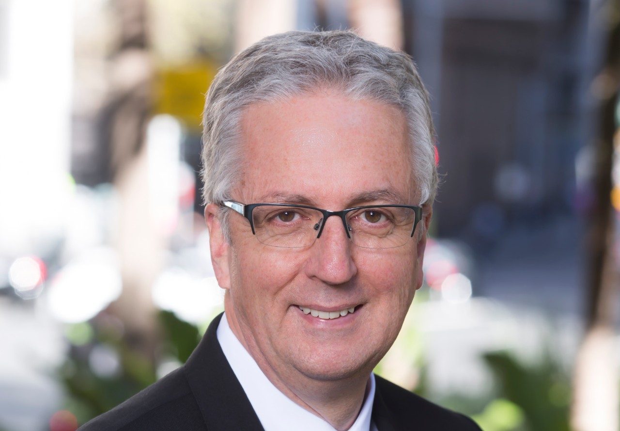 University of Sydney Vice-Chancellor and President, Professor Mark Scott, against a backdrop of sandstone architecture