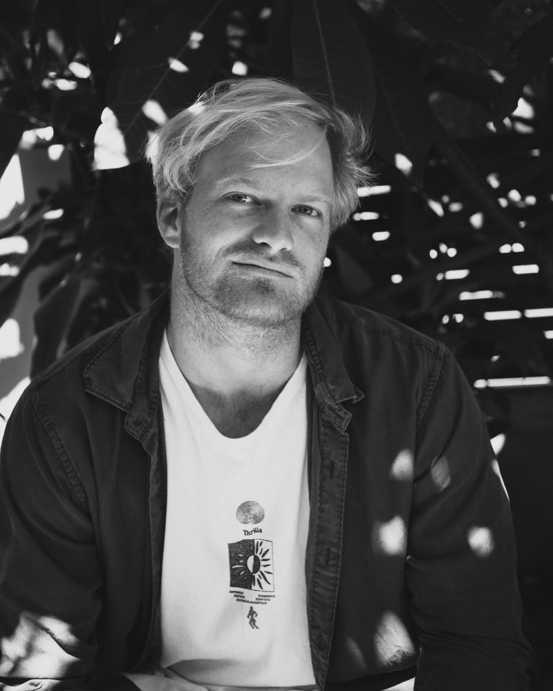 Black and white headshot of a young man