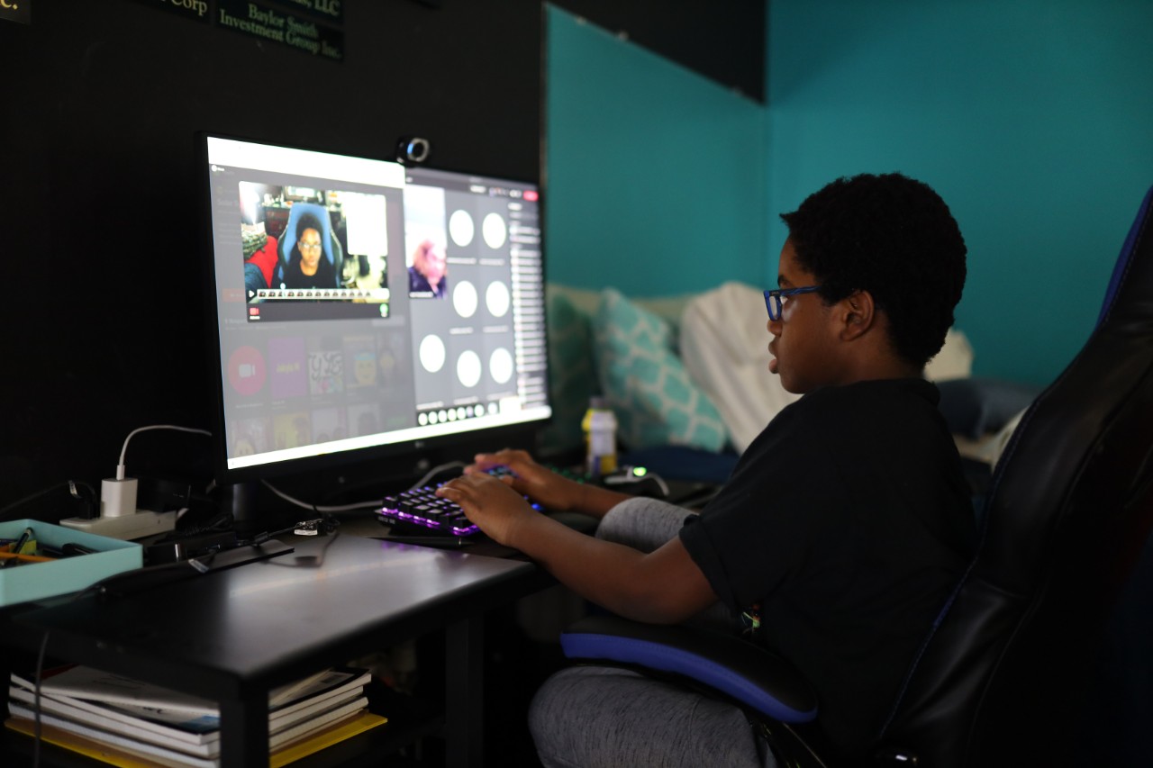 photo of a boy playinf video games in a dark room