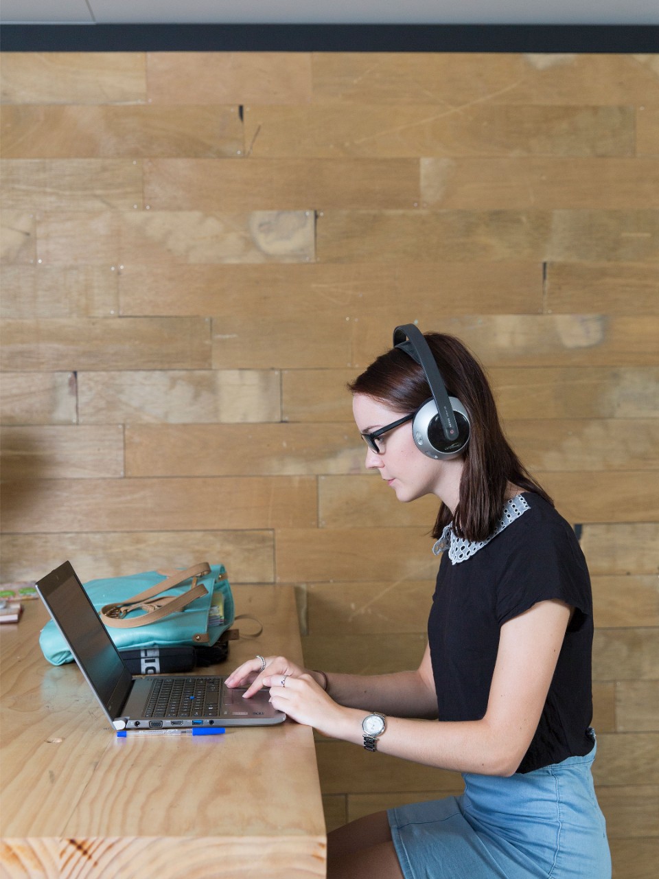 Woman on laptop with headphones