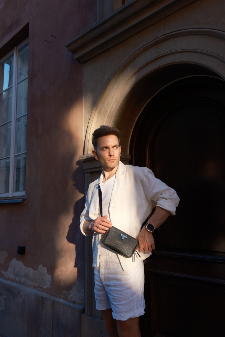 Pasha standing against a standstone background.