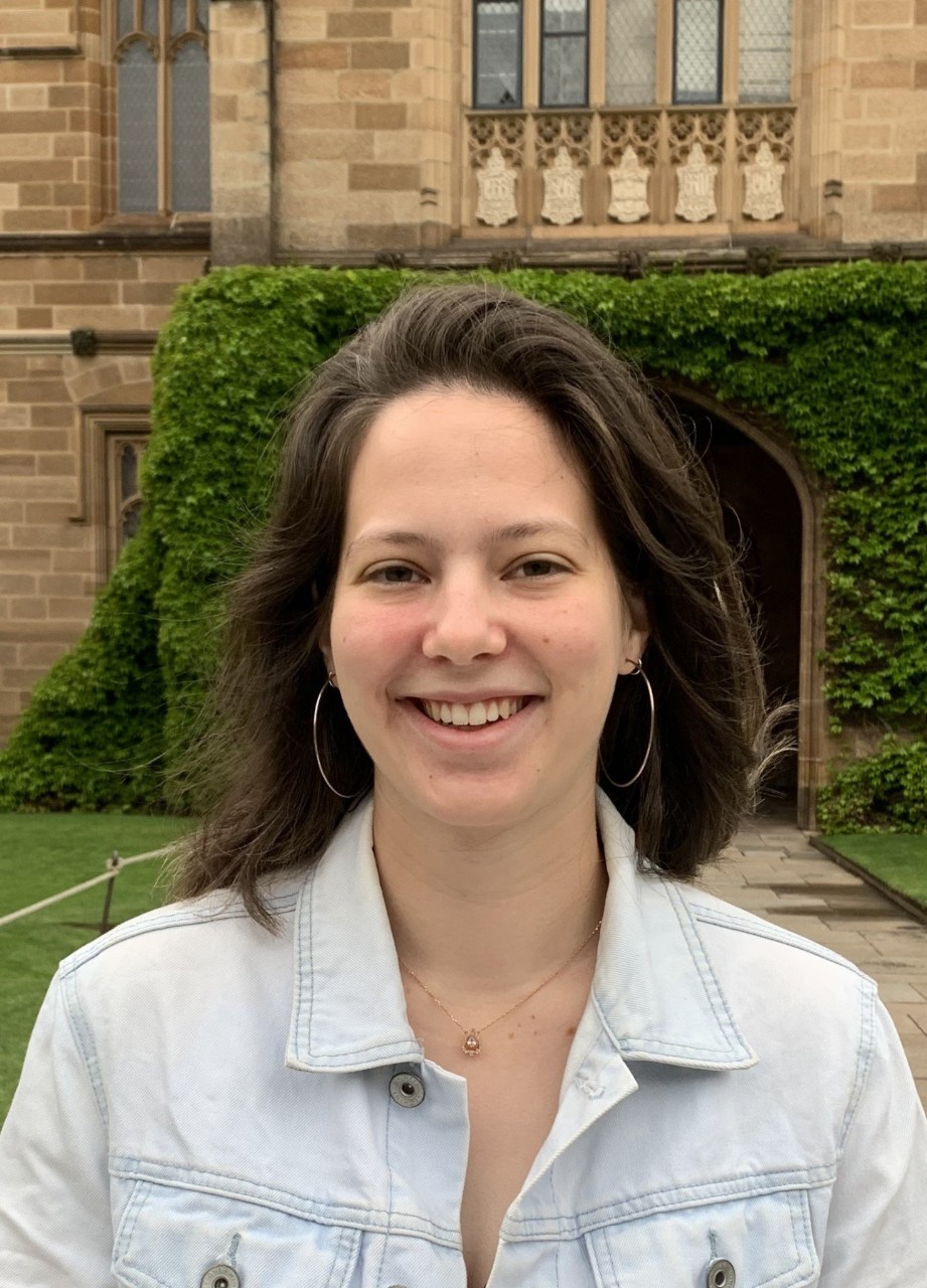 Breanna smiling in front of the University of Sydney Quadrangle 
