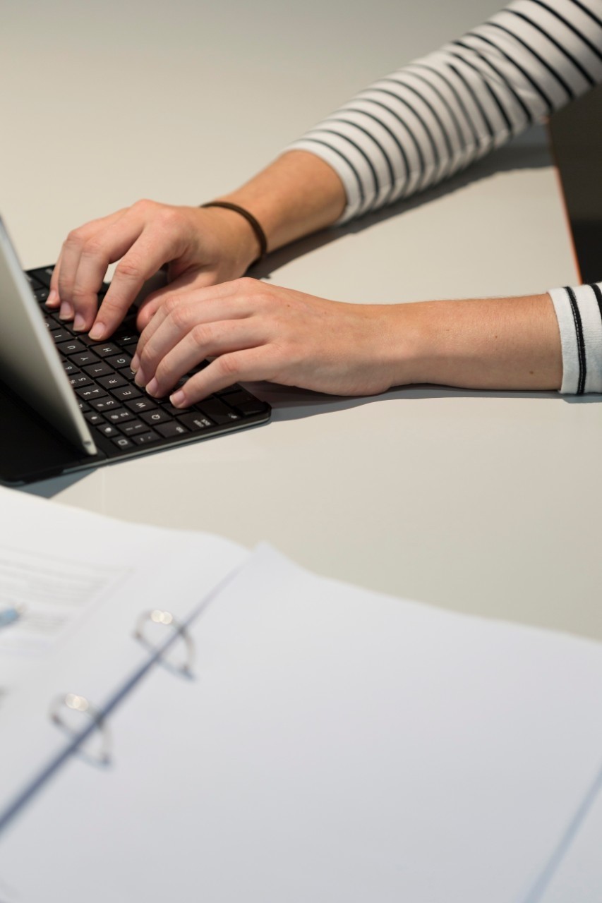 Hands typing on keyboard