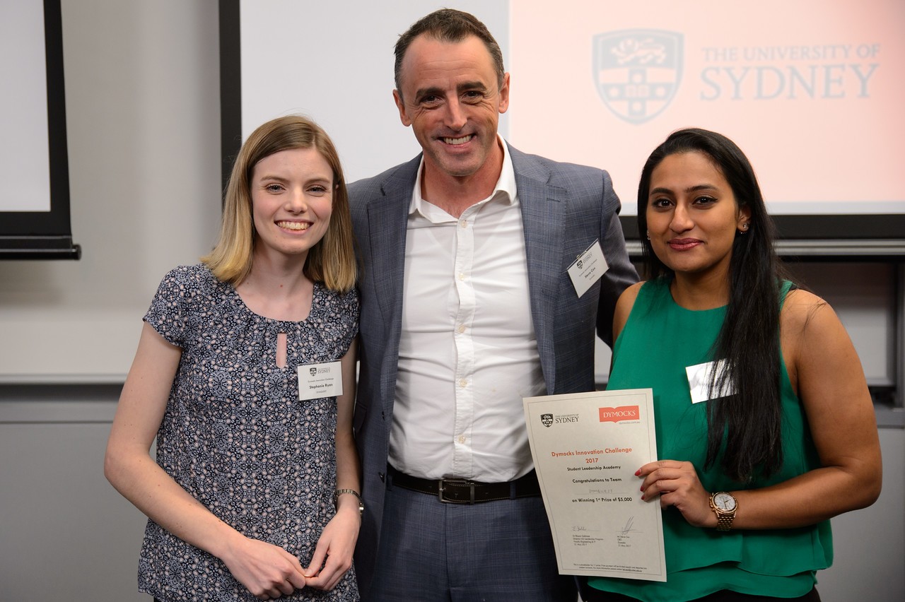 Winning students Stephanie Ryan (L) and Swetha Das (R) with Dymocks Managing Director Steve Cox.