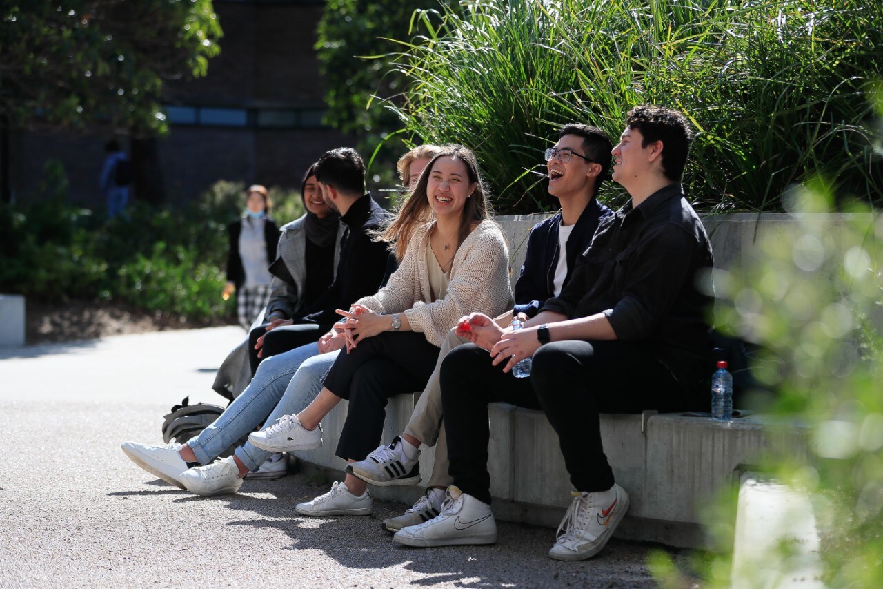 A group of students chatting and laughing 