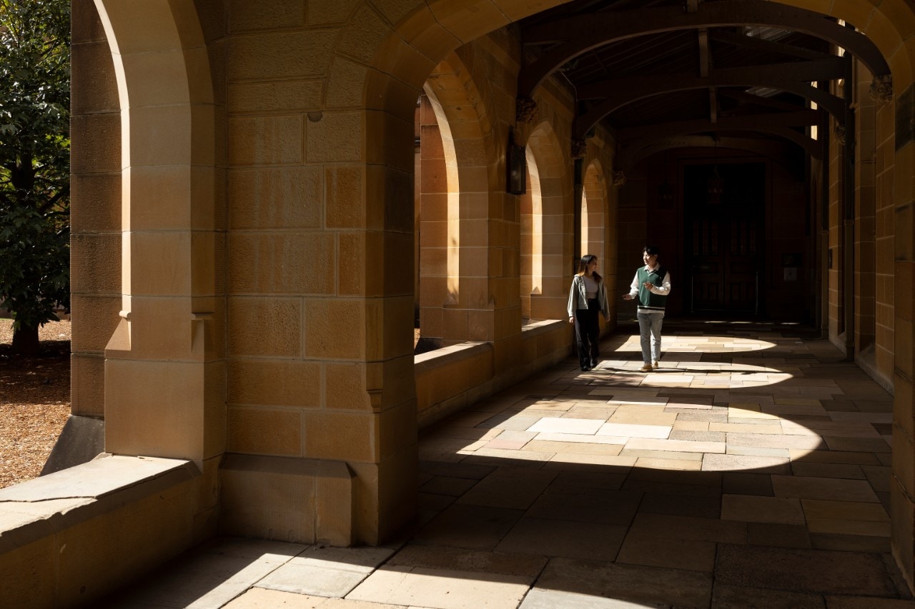 Undergraduate students walking through the quadrangle at the University of Sydney