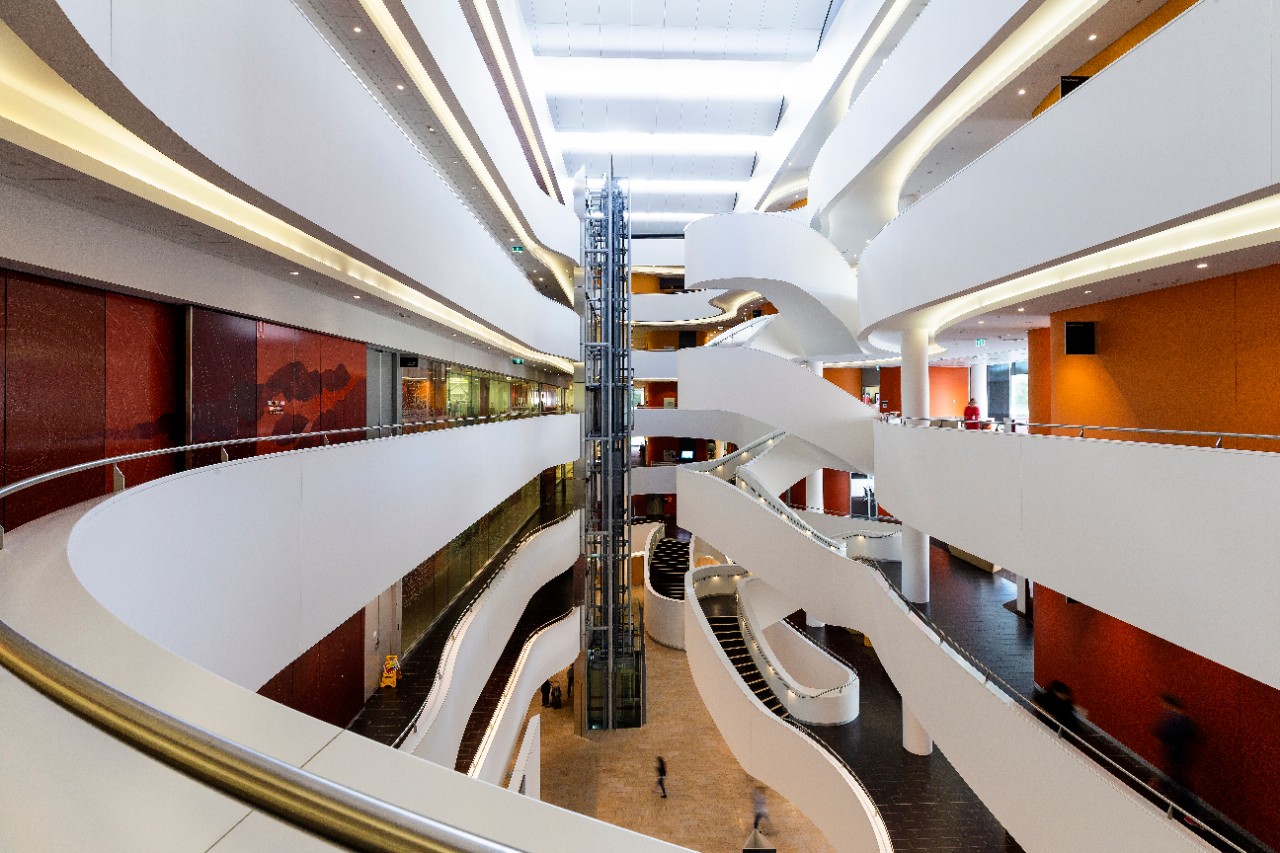 A high indoor floor of the CPC, showing the white staircase and hallways/corridors leading to various rooms.