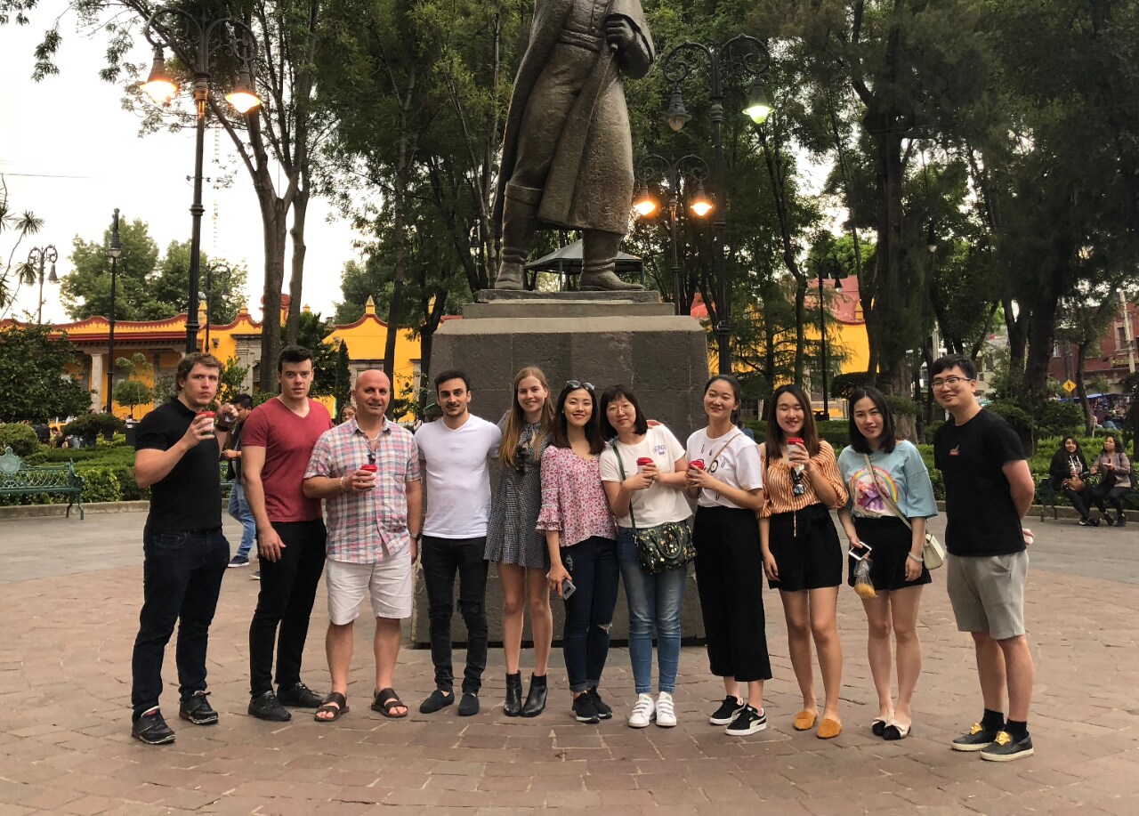Business School students in front of a statue in Mexico