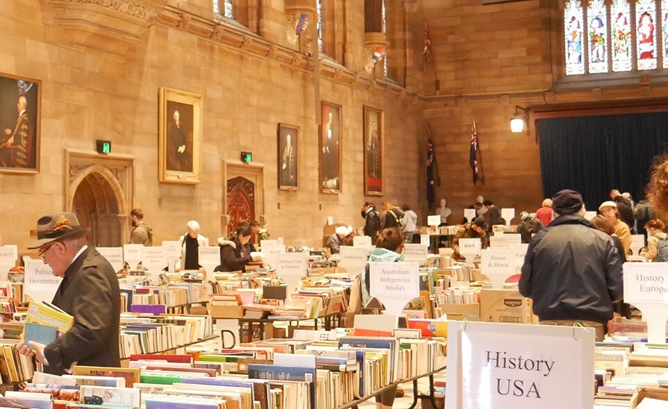 People in the Great Hall looking through books