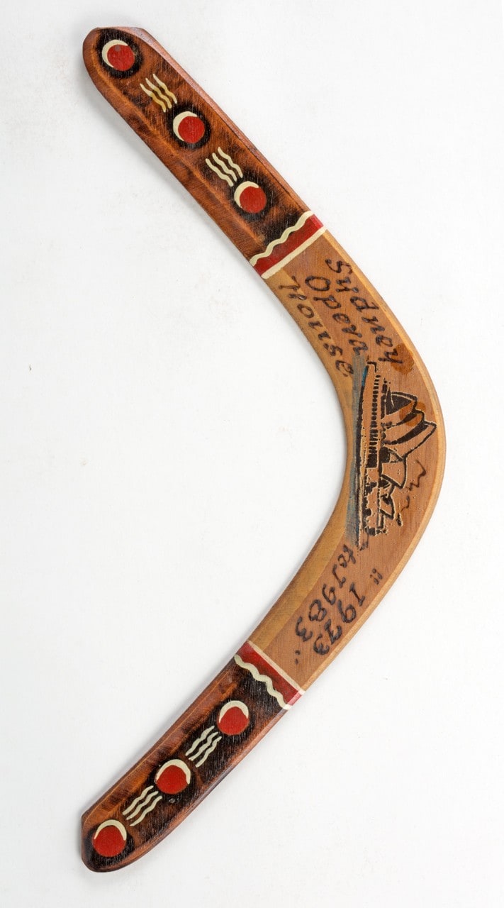 Boomerang with a picture of the Sydney Opera House painted on it.