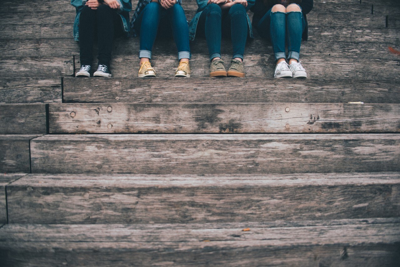 Image: Four people sitting on the steps