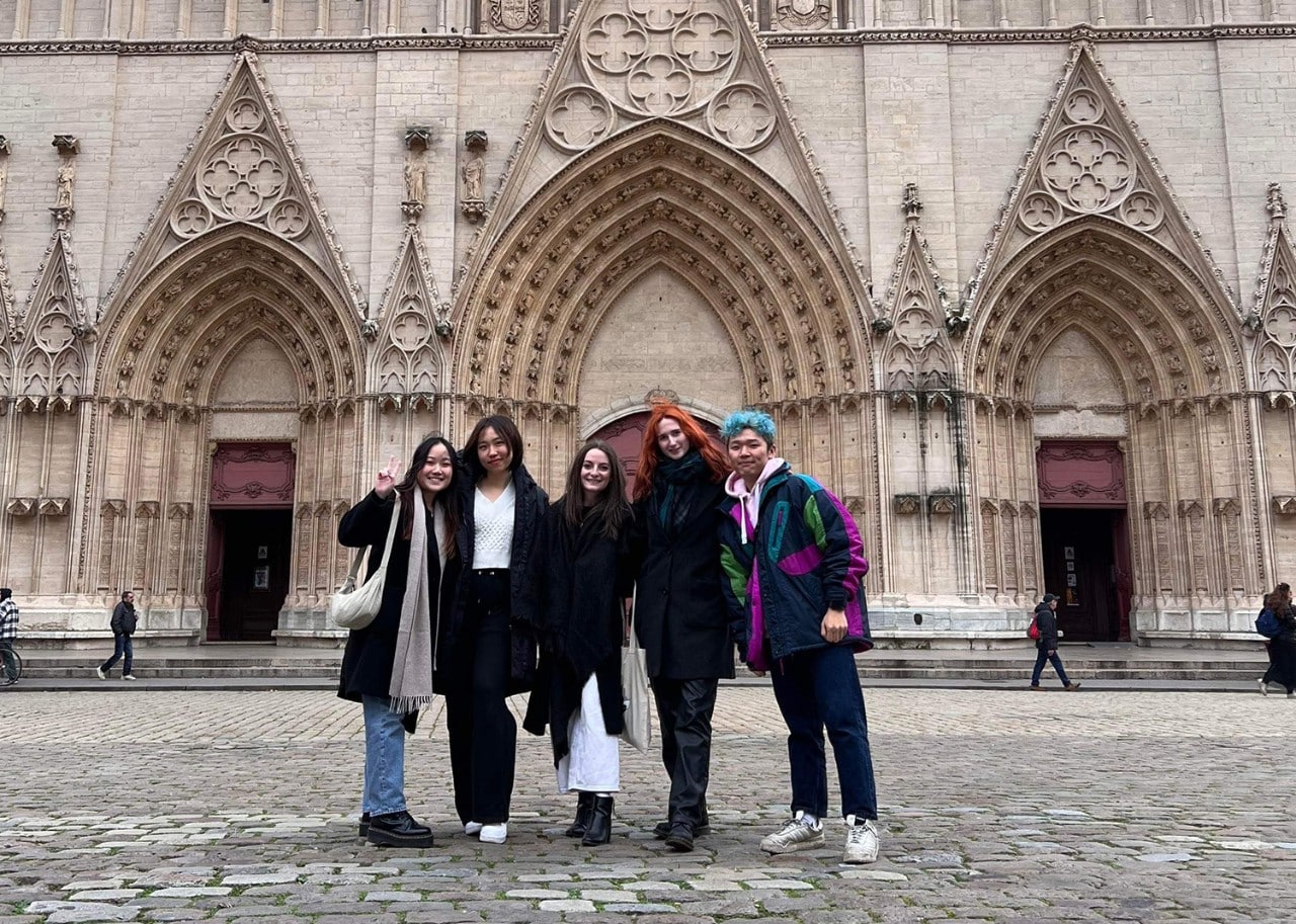Students in front of a historical catheral in France