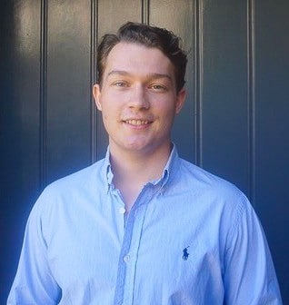 Picture of Harrison Kennedy smiling in blue business shirt.