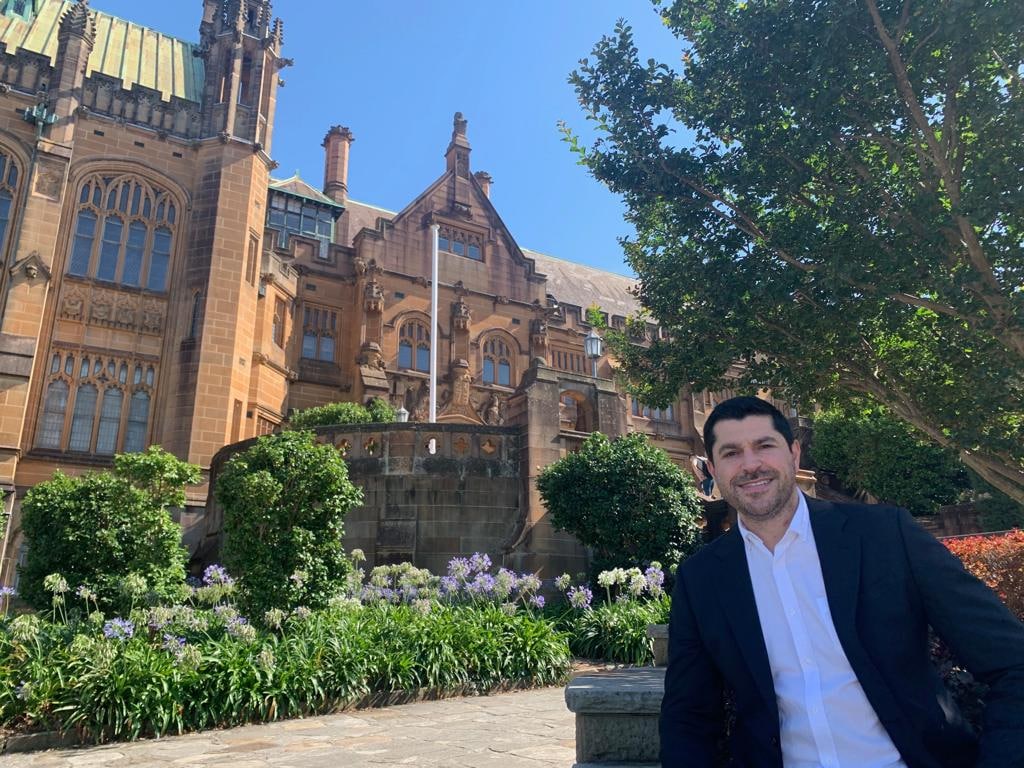 Professor PJ Cullen poses outside of a University of Sydney sandstone building