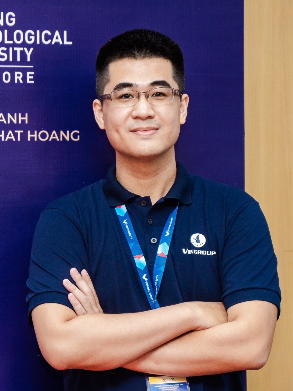 Nguyen Tran standing with arms crossed