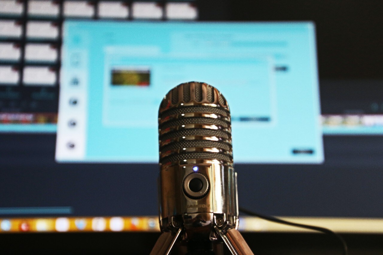 Microphone sitting in front of laptop computer