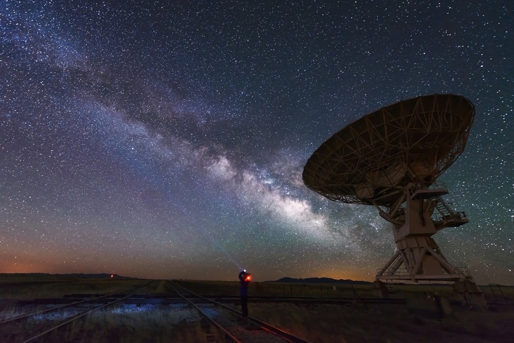 An image of a satellite pointed at the visible milky way galaxy. 