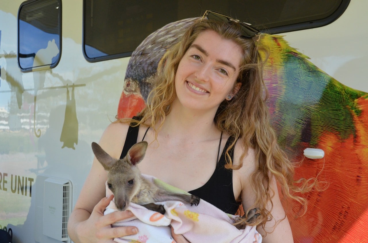 Rebecca Woods holding a joey in her arms