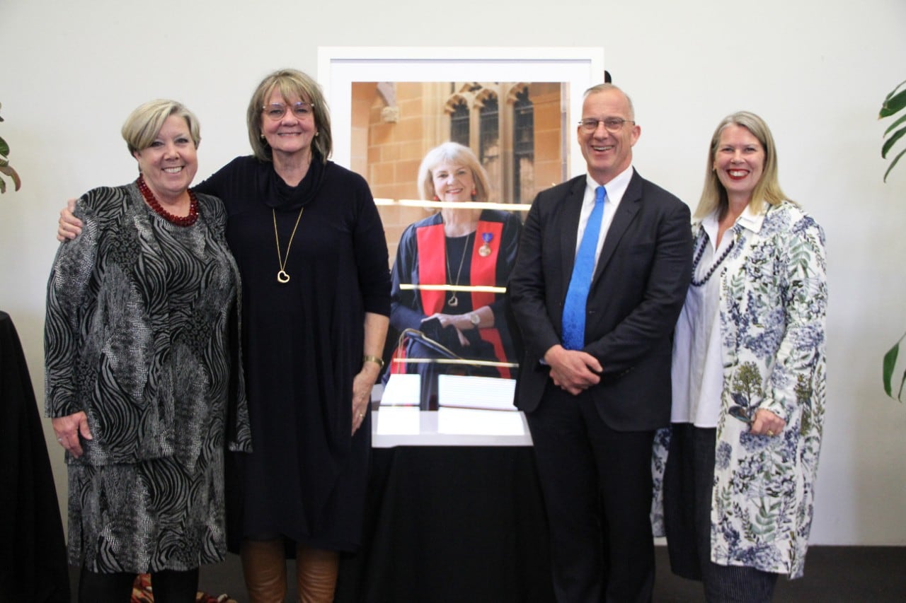 Picture of Mary Chiarella, Emeritus Professor Jill White, Dr Michael Spence AC, Professor Donna Waters standing with the photo taken of Jill White