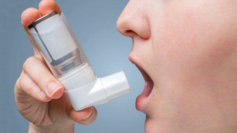 Person using asthma puffer