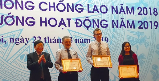 Professor Guy Marks, Associate Professor Greg Fox and Dr Nguyen Thu Anh receiving a national award from the Ministry of Health in 2019.