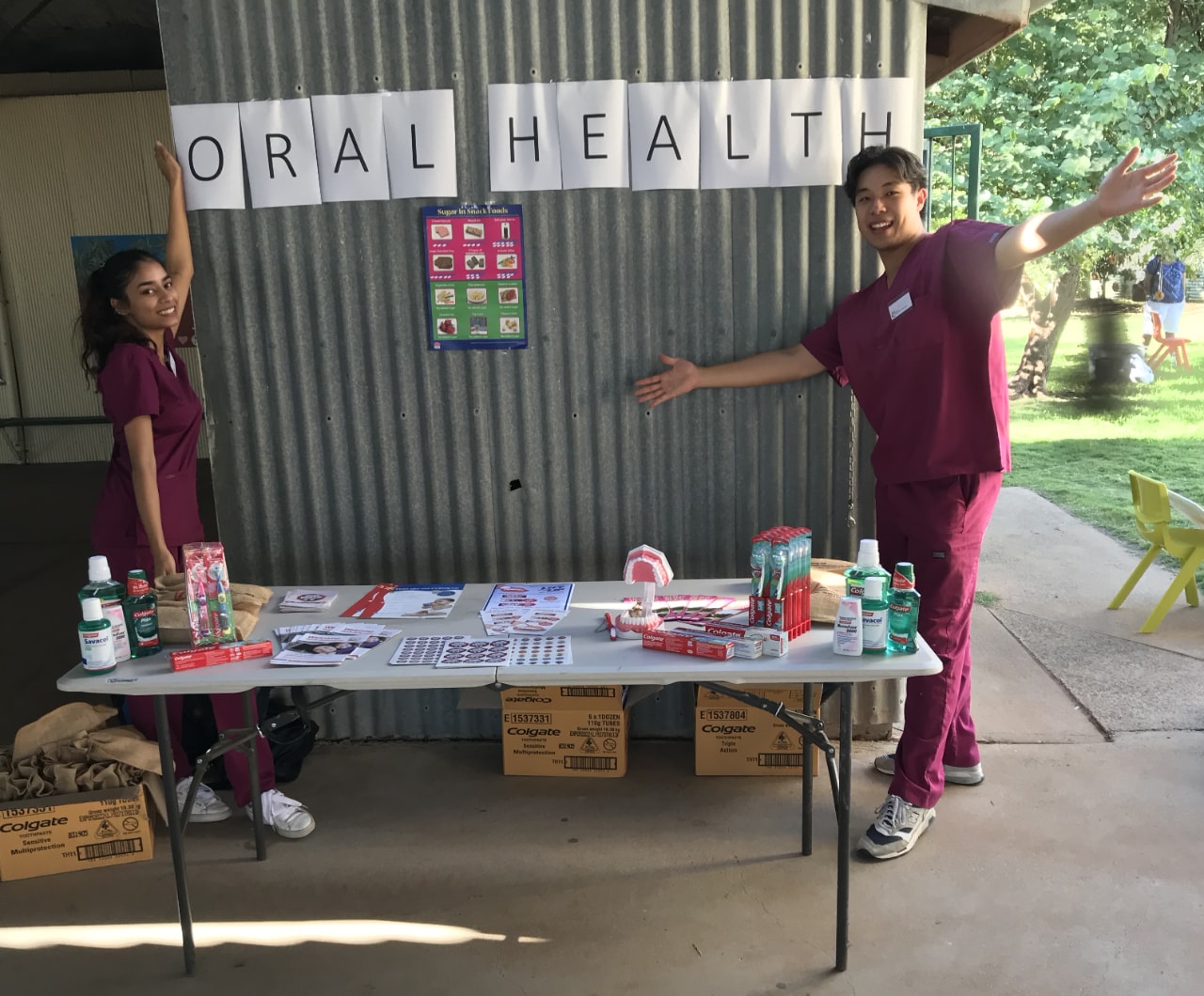 Amreen Khan and Ricky Zhang with their oral health stand at a primary school fete in Bourke