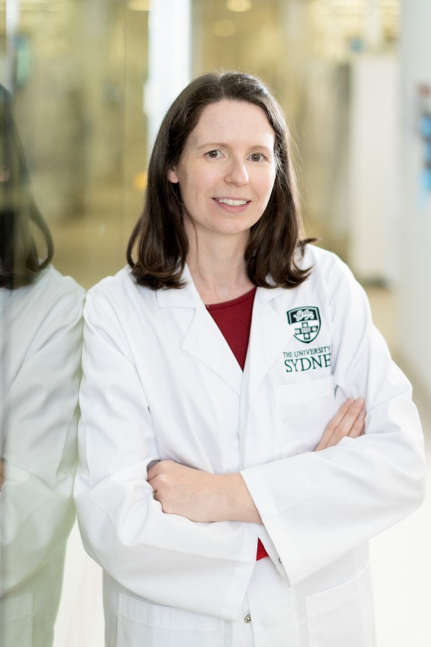 Dr Erin Shanahan standing with a white lab coat