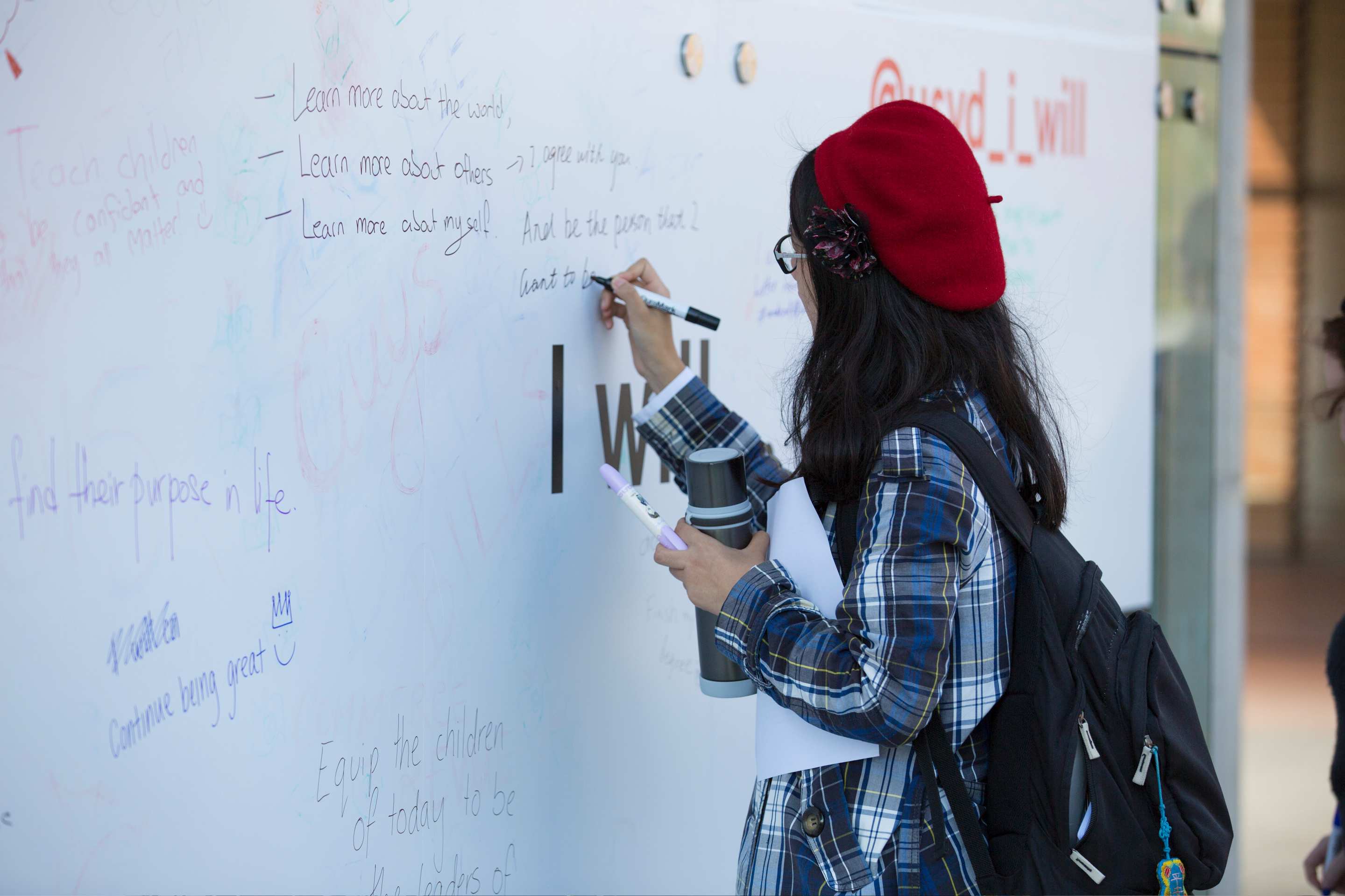 Girl at I will message wall during brand campiagn