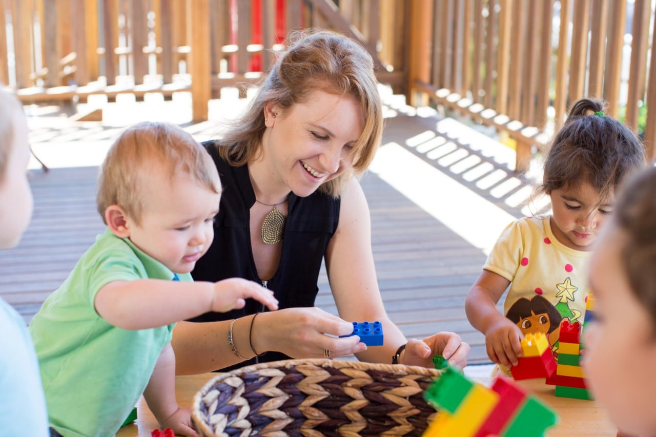 Health Sciences student Rachel Jaros pictured playing with children at Cullunghutti Aboriginal Child and Family Centre