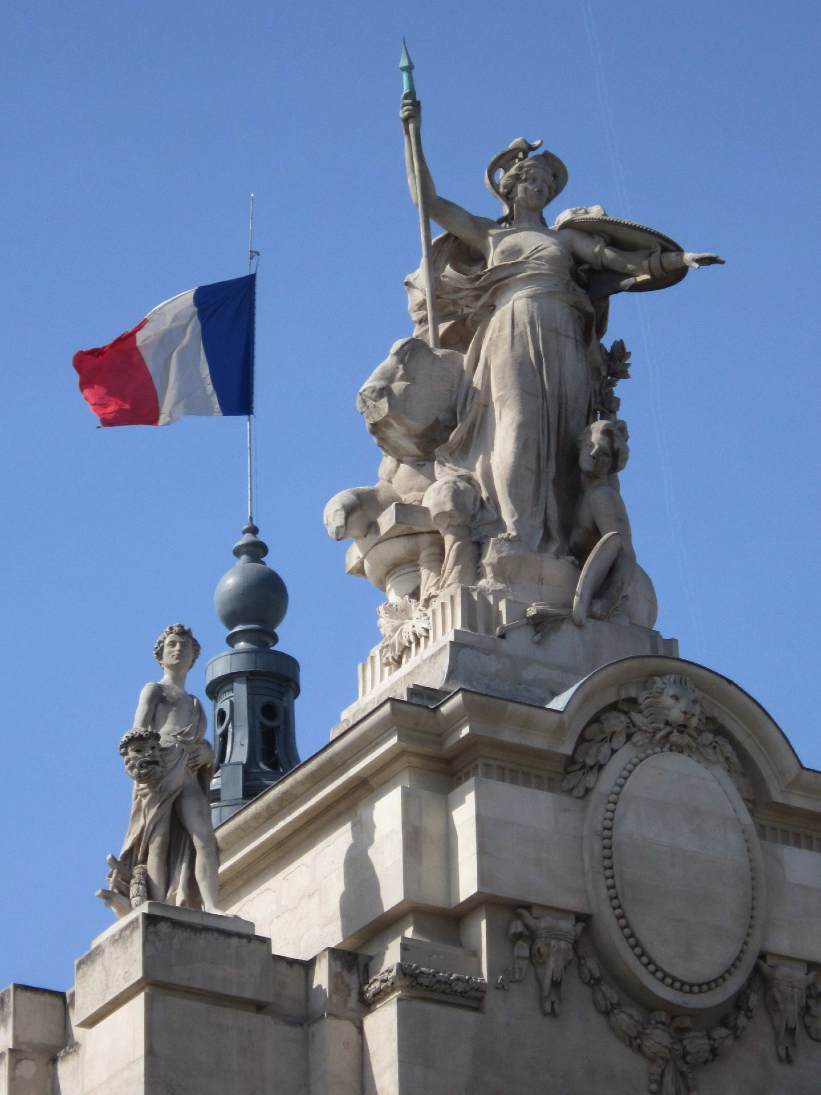 The French flag flies over a monument in Paris