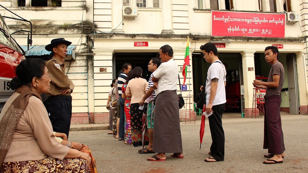 People stand outside a polling station in Myanmar. Image: Prachatai/Flickr.