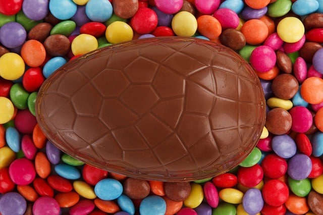 Chocolate Easter egg surrounded by smarties. 