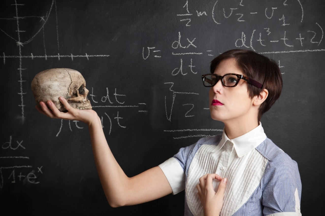 An image of a student holding a skull, emulating the Yorick soliloquy from Hamlet. Image: iStock