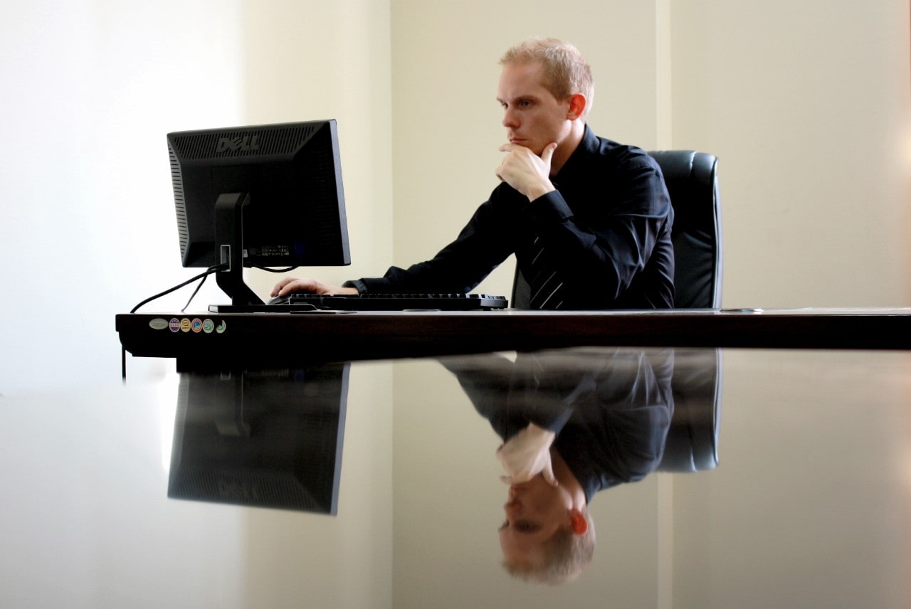 A man looking at his computer. 