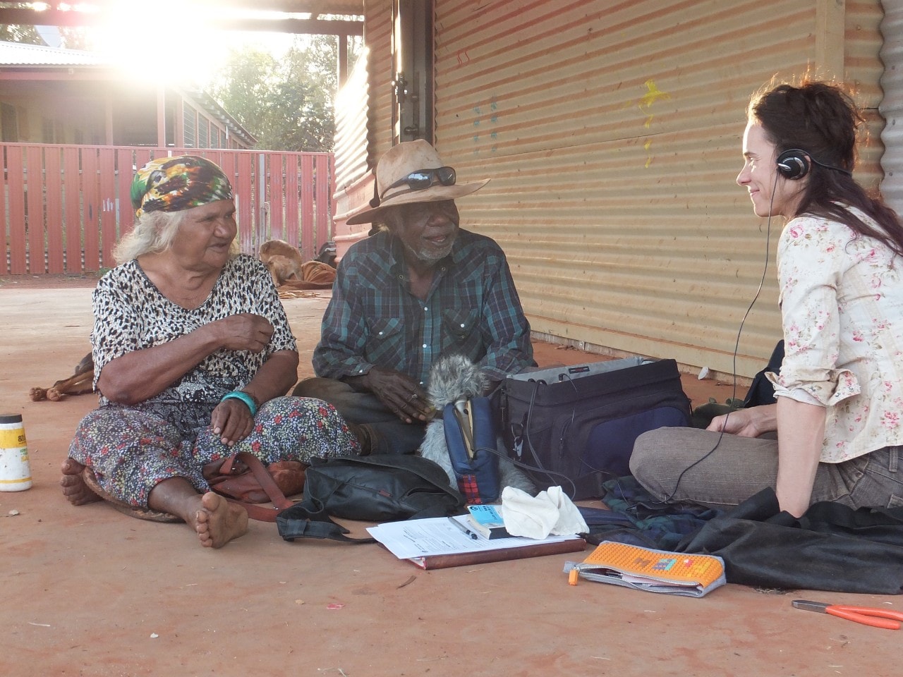 A photo of Dr Myfany Turpin working with Marie Mudgedell and Patrick Smith in 2016 to document songs in Balgo, Western Australia.