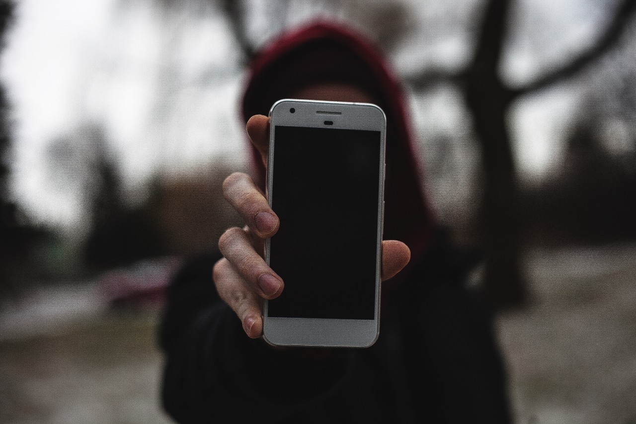 A hand holding a smartphone. Image: Justin Main/Unsplash