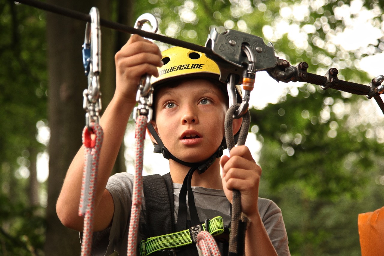 A child completes a high ropes course
