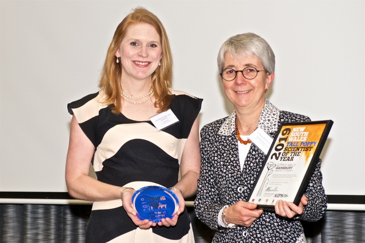 photo of Associate Professor Sally Gainsbury holding her award with Professor Barbara Messerle, the chair of the Tall Poppy selection committee. Professor Messerle is Executive Dean of Science at Macquarie University and takes up the position of Provost at University of Sydney in September. Photo: Rick Gates Photography.