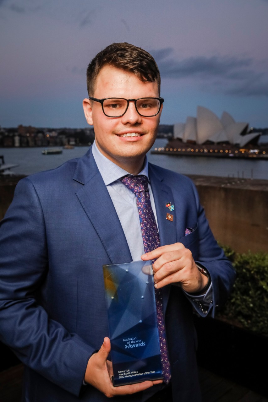 Corey Tutt on top of Sydney's Museum of Contemporary Art holding his award