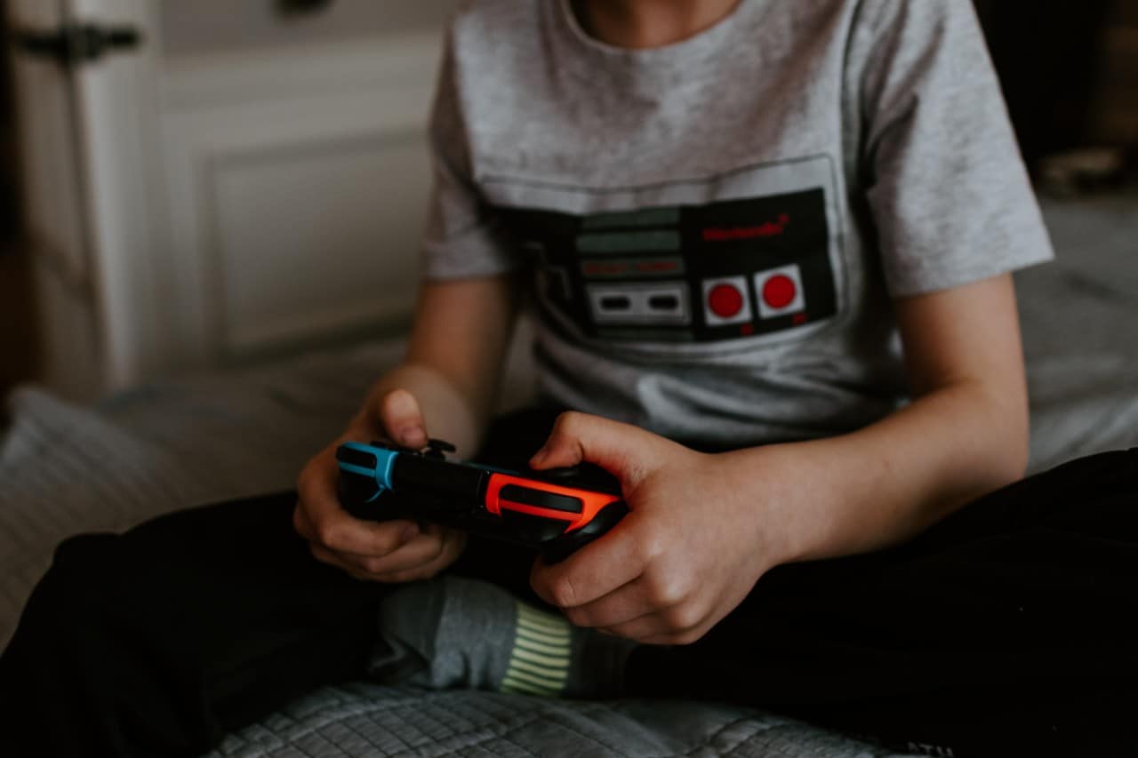 Young boy playing video game. Photo: Kelly Sikkema/Unsplash