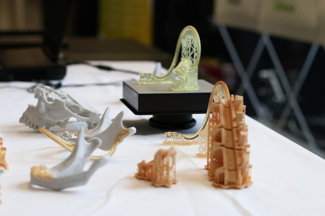 3D printed implants for neck and head surgery displayed on a table.