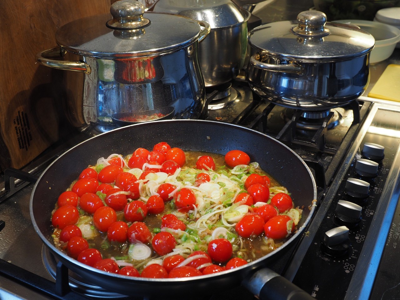photo of a gas cooker with a pan full of vegetables